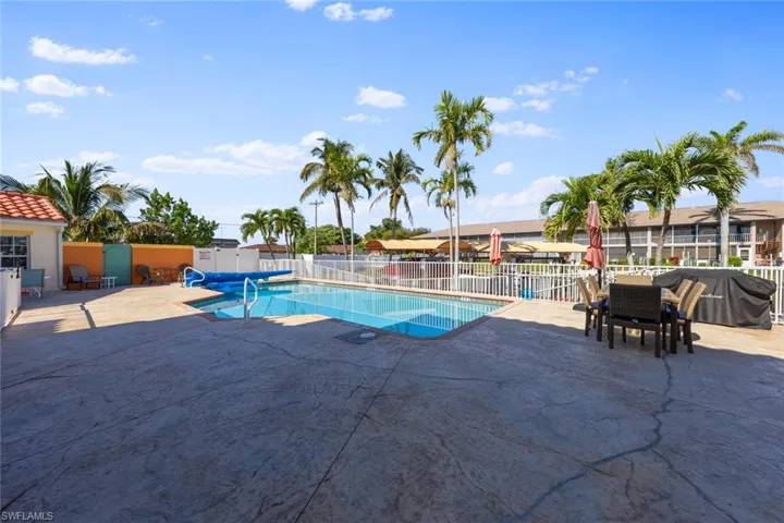 View of swimming pool featuring fence, a patio area, and a fenced in pool