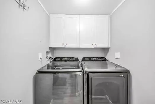 Laundry area with cabinet space and separate washer and dryer