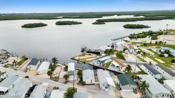 Aerial view of residential area featuring a nearby body of water
