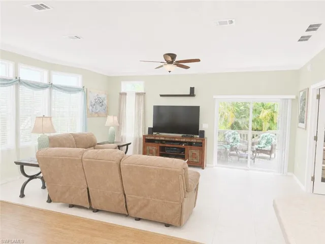 Bright interior space featuring light-colored flooring and ample natural light with multiple windows