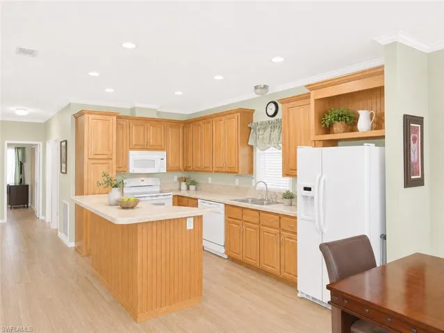 Kitchen featuring blonde wood cabinetry, an island