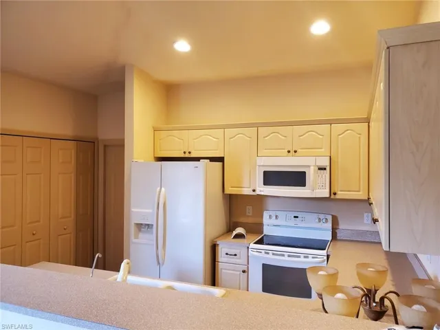 Kitchen with sink and white appliances