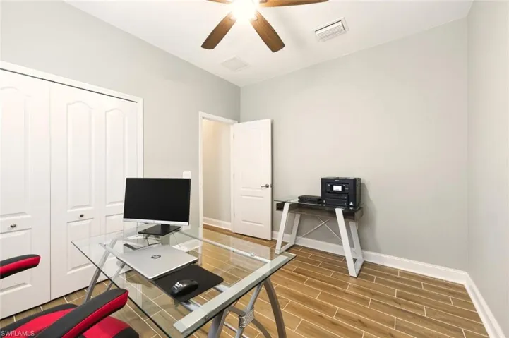 Office area with wood tiled floors and ceiling fan