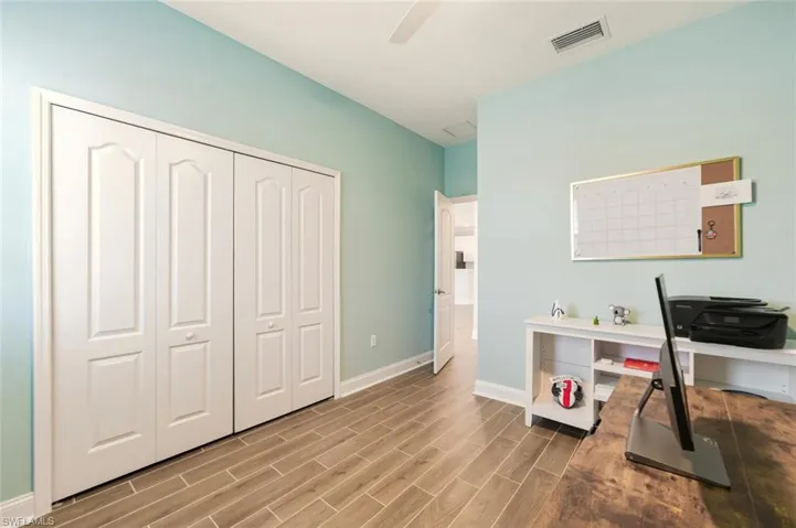 Home office featuring wood finish floors and a ceiling fan