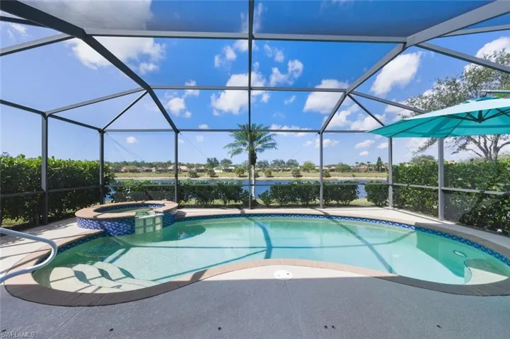 Integrated pool / spa featuring a sunroom, a water view.
