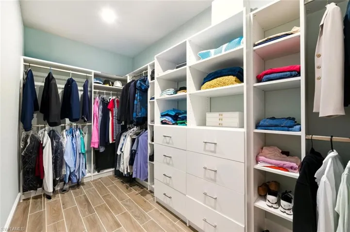 Walk in closet featuring wood tiled floors
