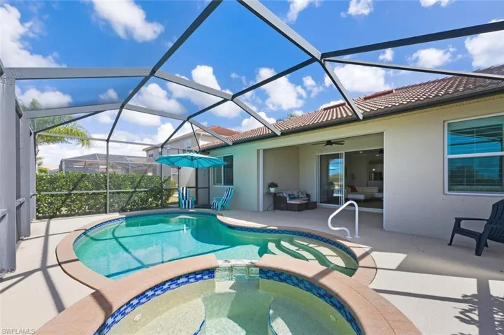 Integrated pool / spa with a sunroom, glass enclosure, a patio area, and an outdoor lounge area