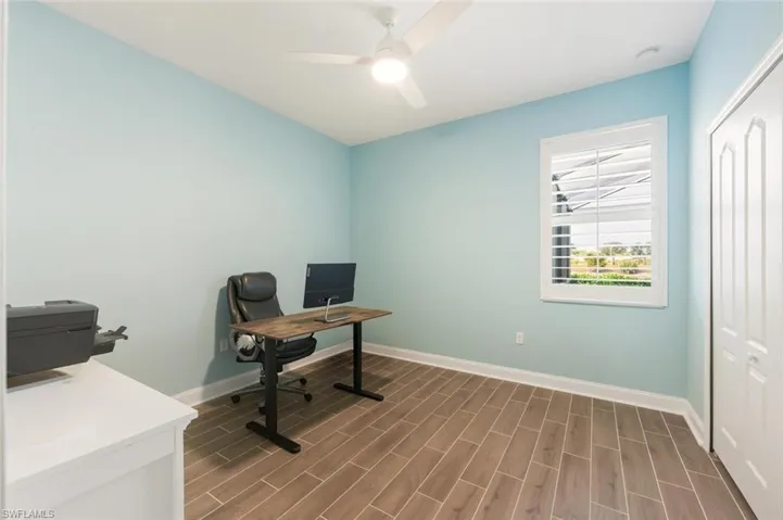 Home office featuring wood tiled floors and ceiling fan