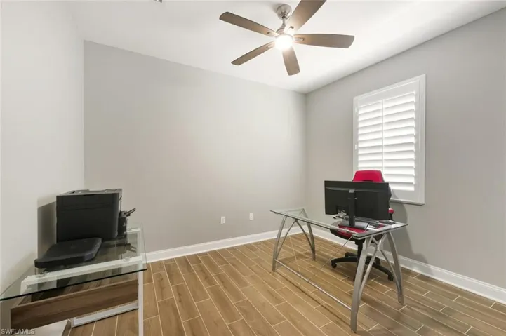 Office area featuring wood tile floors and ceiling fan