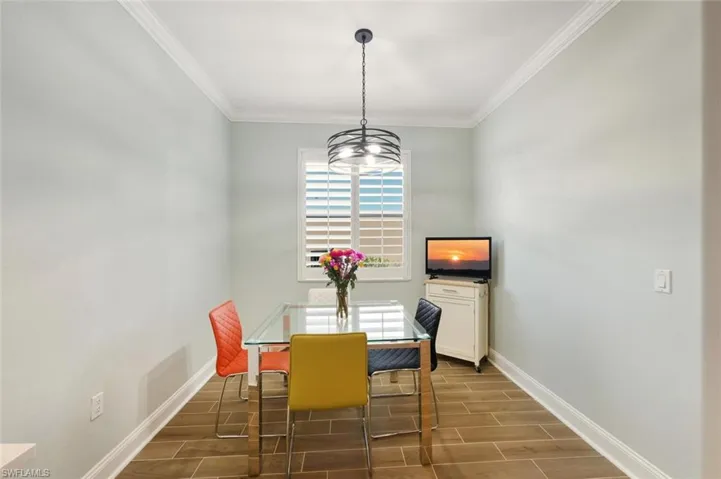 Dining room with wood tiled floors and ornamental molding
