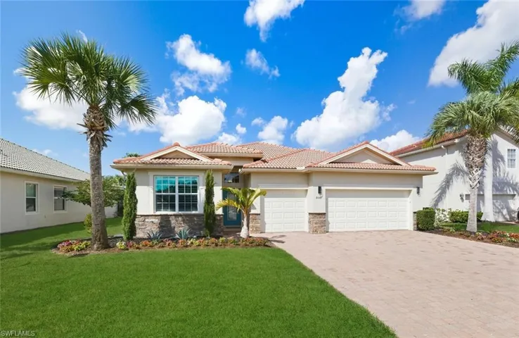 Mediterranean / spanish-style home with a tiled roof, an attached garage, driveway, stucco siding, and a front yard