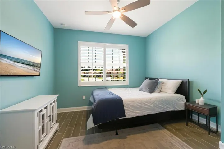 Bedroom featuring wood finish floors and ceiling fan