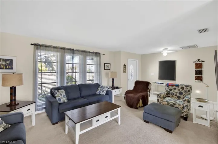 Living room featuring light carpet