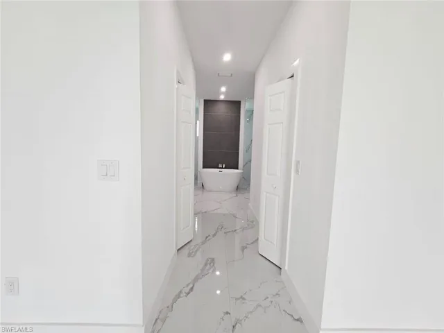 Corridor featuring light tile patterned flooring