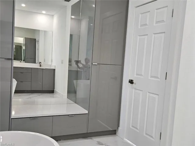 Full bathroom with vanity, shower with separate bathtub, and toilet