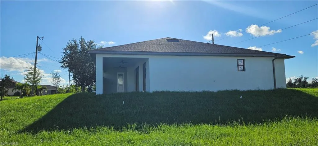 View of side of property featuring a yard