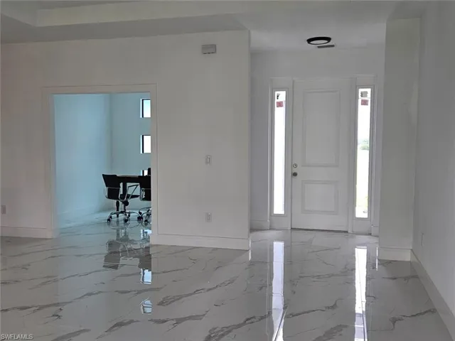 Foyer entrance with light tile patterned floors