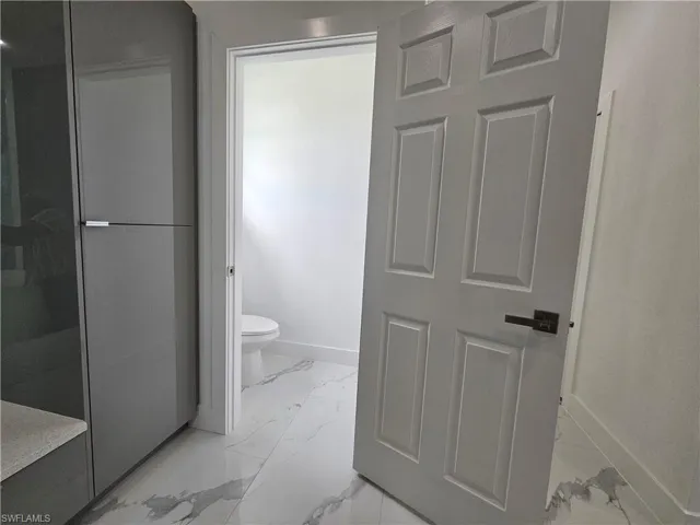 Bathroom featuring tile patterned floors and toilet