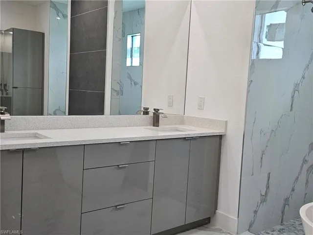 Bathroom featuring tile patterned flooring and dual bowl vanity