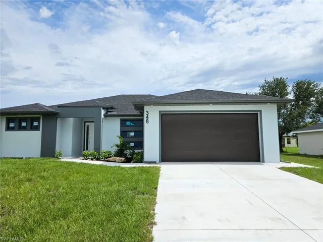 Prairie-style home with a garage and a front yard
