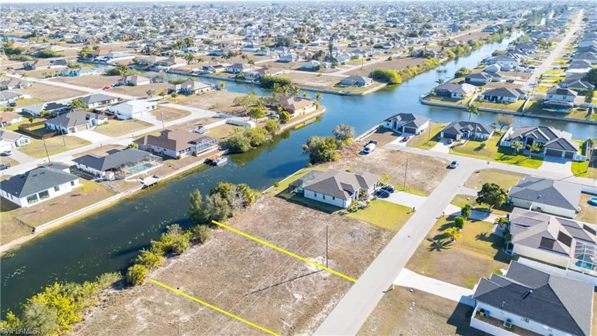 Aerial view of property's location featuring nearby suburban area and a nearby body of water