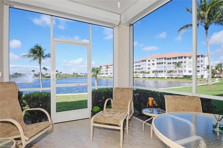 Sunroom / solarium with a water view and wood finished floors