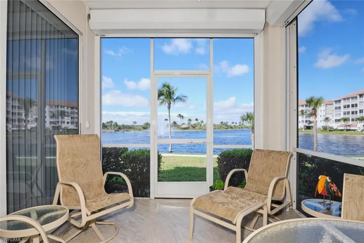Sunroom / solarium featuring a water view