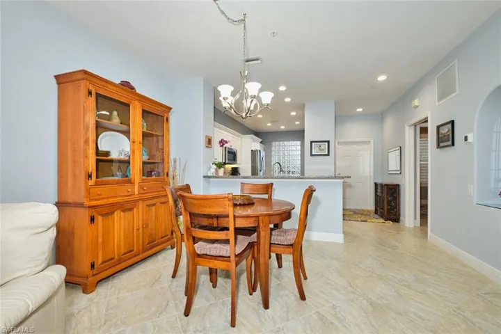 Dining room with recessed lighting and a chandelier