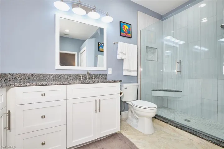 Full bathroom with vanity and a stall shower