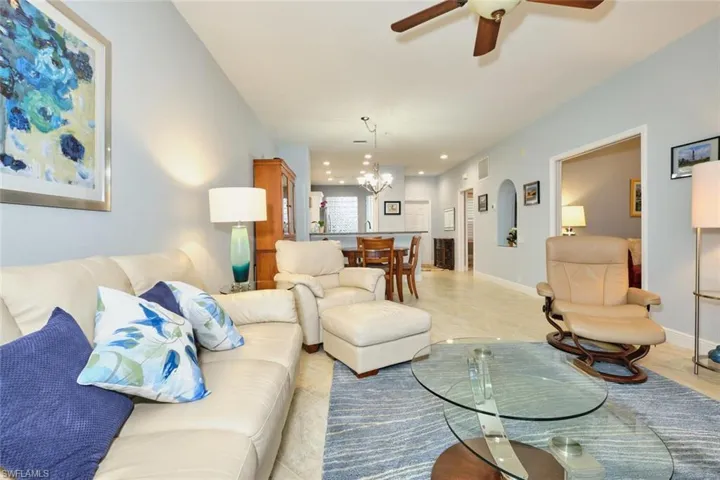 Living room with ceiling fan, recessed lighting, and a chandelier