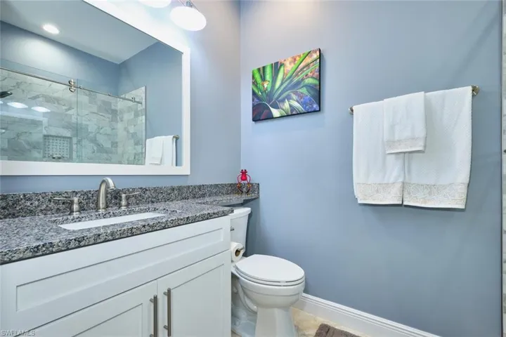 Full bathroom featuring vanity and a stall shower