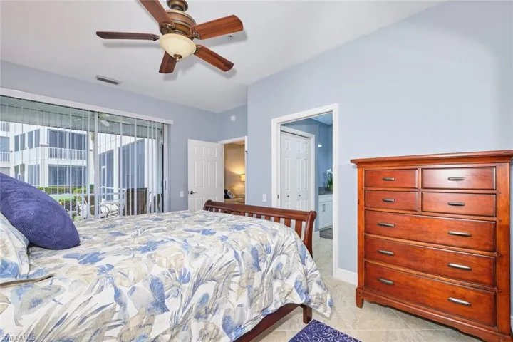 Bedroom featuring access to exterior, ceiling fan, connected bathroom, and light tile patterned flooring