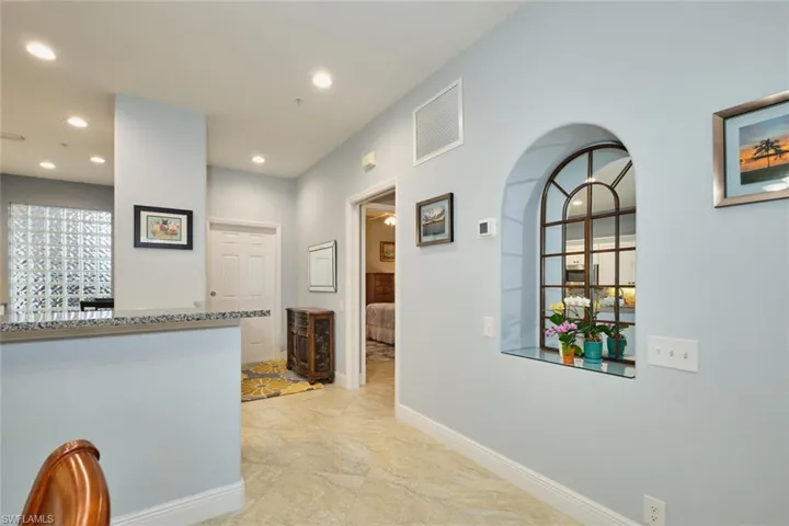 Corridor with baseboards and recessed lighting