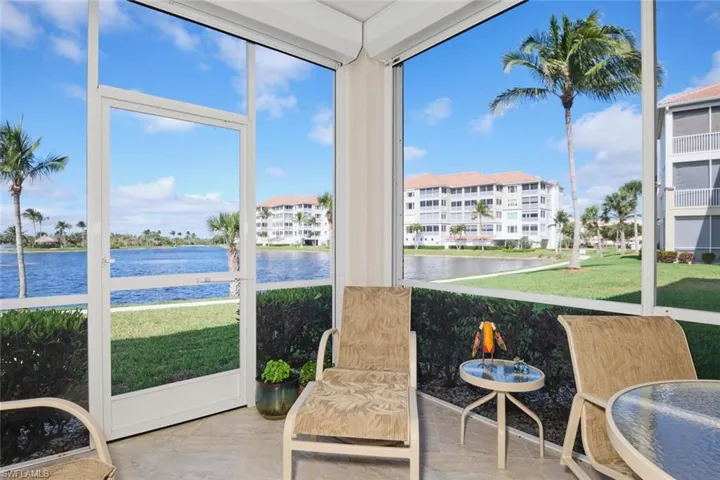 Sunroom / solarium featuring a water view