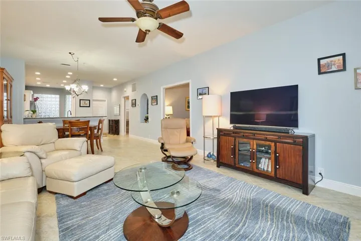 Living area with ceiling fan, a chandelier, and recessed lighting