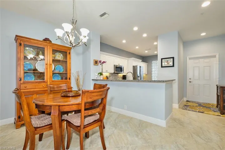 Dining space with a chandelier and recessed lighting