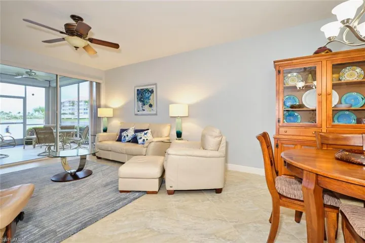 Living room with ceiling fan and a chandelier