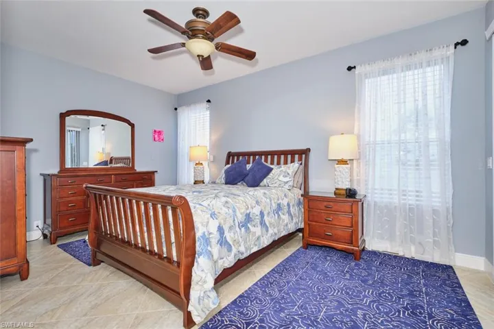 Bedroom featuring a ceiling fan and baseboards