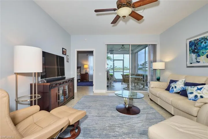 Living room featuring tile patterned flooring and a ceiling fan
