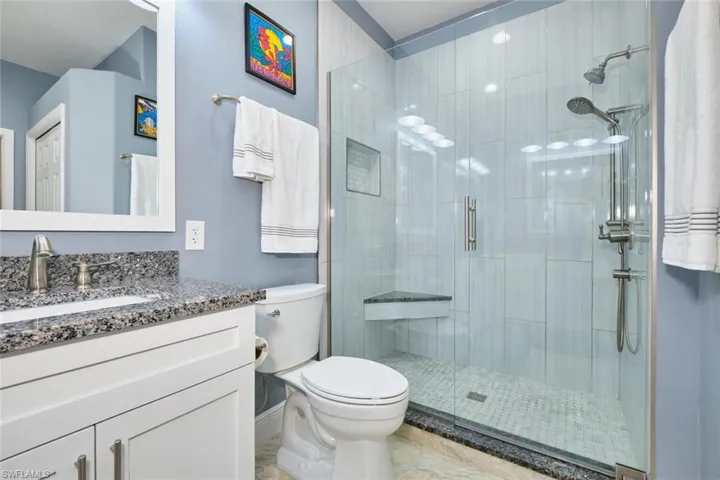 Bathroom with vanity and a stall shower