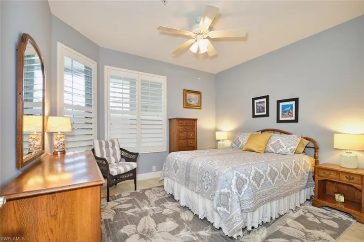Bedroom with ceiling fan and baseboards