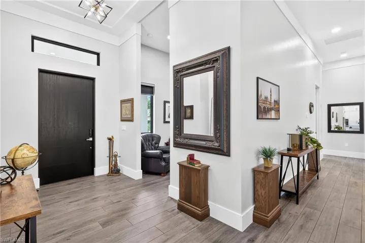 Entrance foyer with a towering ceiling and light wood-style floors
