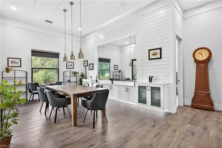 Dining area with dark wood-style floors and recessed lighting