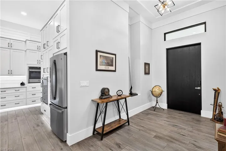 Entryway with a towering ceiling and light wood-style floors