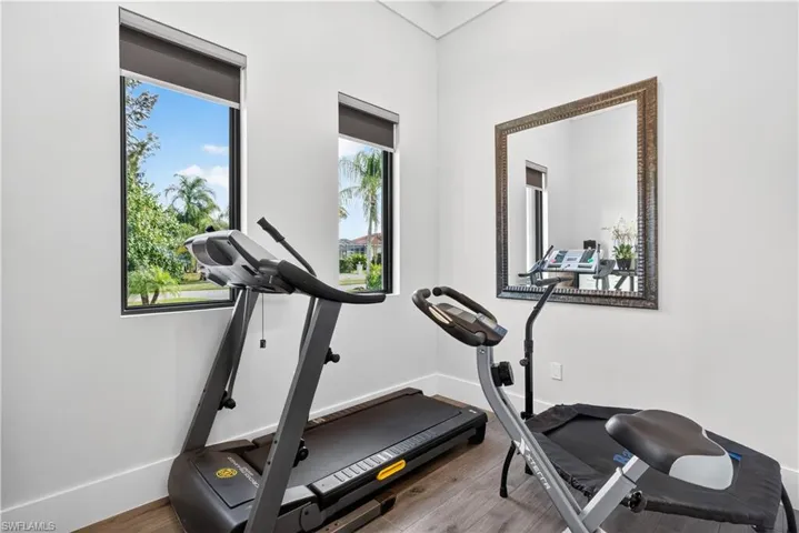Exercise area featuring wood finished floors and baseboards