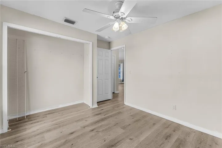 Unfurnished bedroom featuring ceiling fan and light wood-type flooring