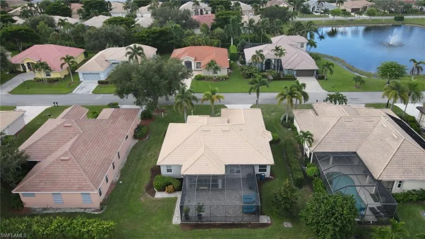 Aerial view of residential area featuring a nearby body of water