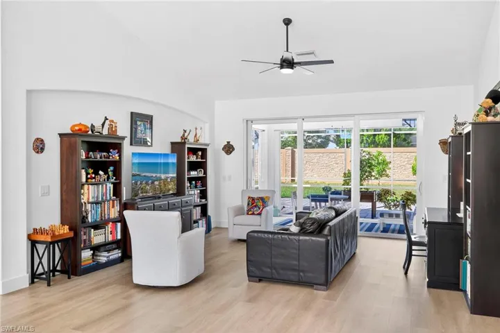 Living area with light wood finished floors and a ceiling fan