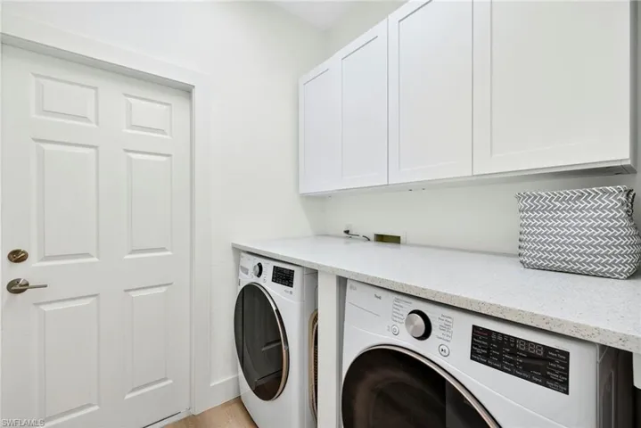 Laundry Room featuring cabinet space and independent washer and dryer