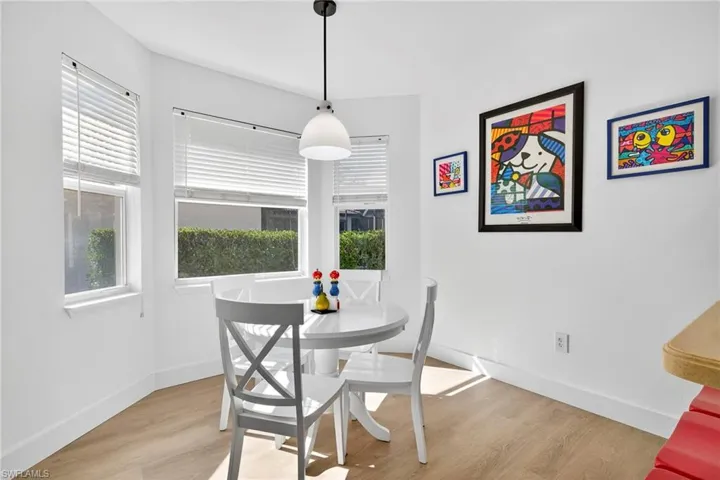 Kitchen eating area with light wood-style floors